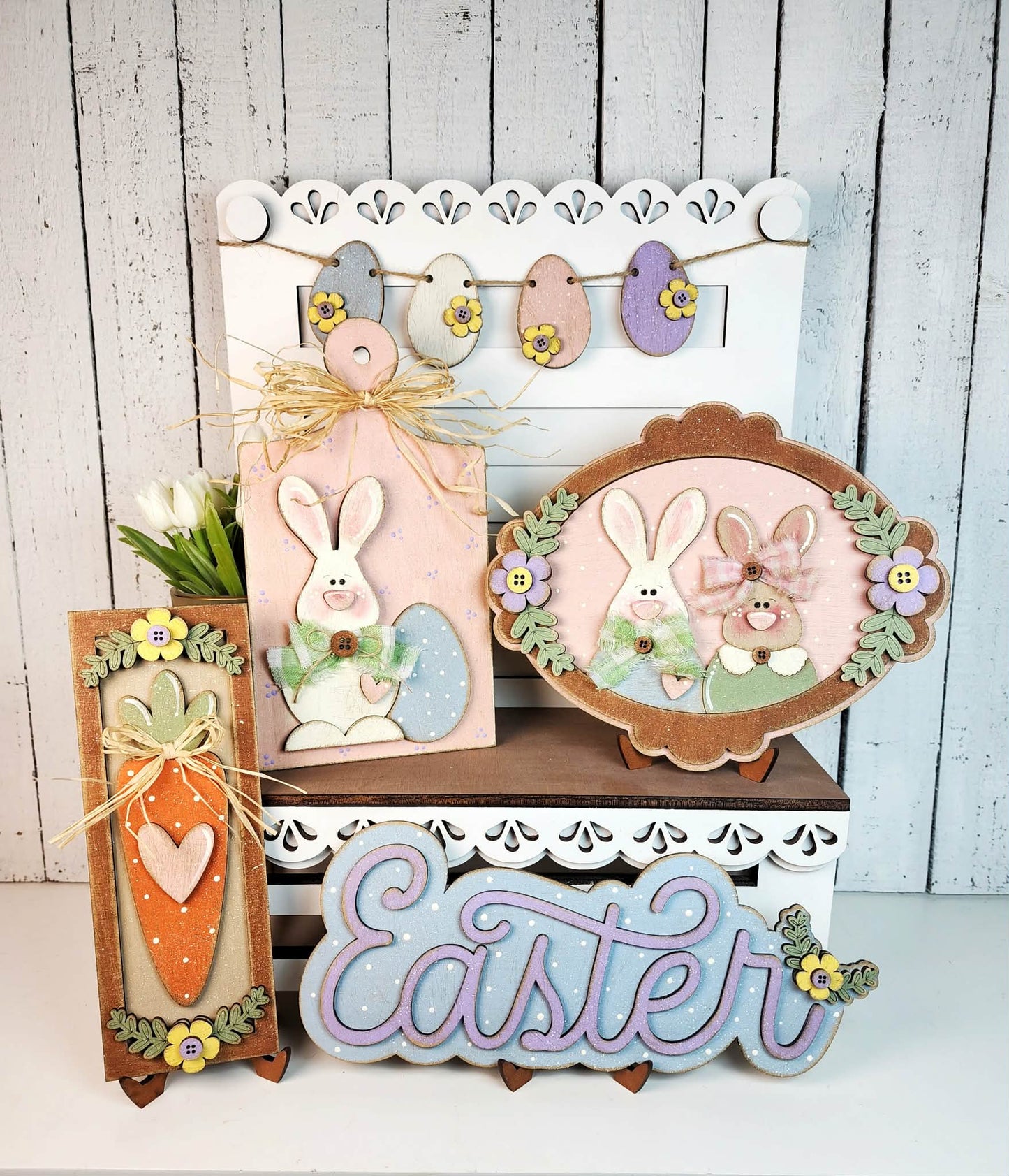 Decorative Easter signs with bunnies, eggs, and 'Easter' text on a wooden surface.